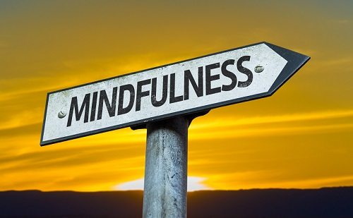 Mindfulness sign with a sunset background