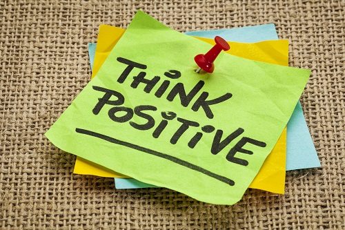 think positive - motivational reminder - handwriting on sticky